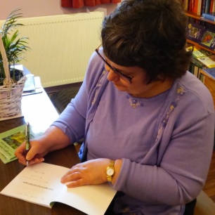 Signing books for a friend. Image by Adrian Symes